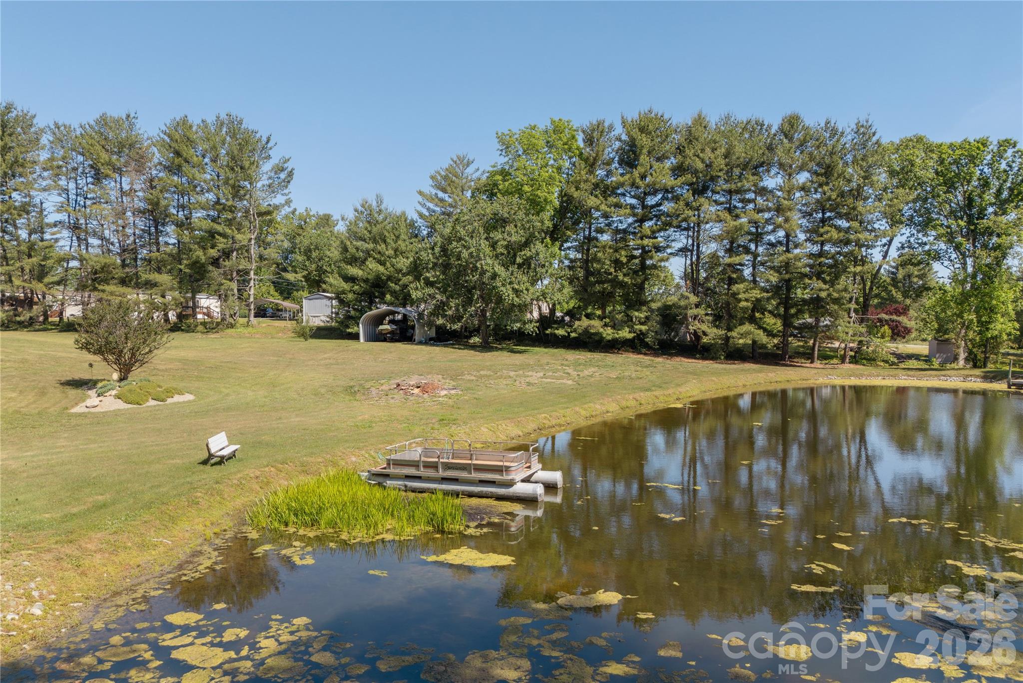231 Allen Road East Flat Rock, NC 28726 - Photo 37 of 42 a view of a lake with a yard