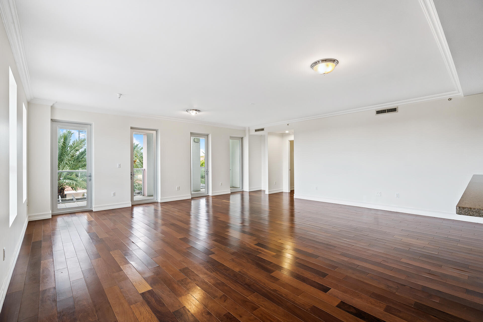 455 East Palmetto Park Road, Unit 3W Boca Raton, FL 33432 - Photo 11 of 40 a view of an empty room with wooden floor and a window