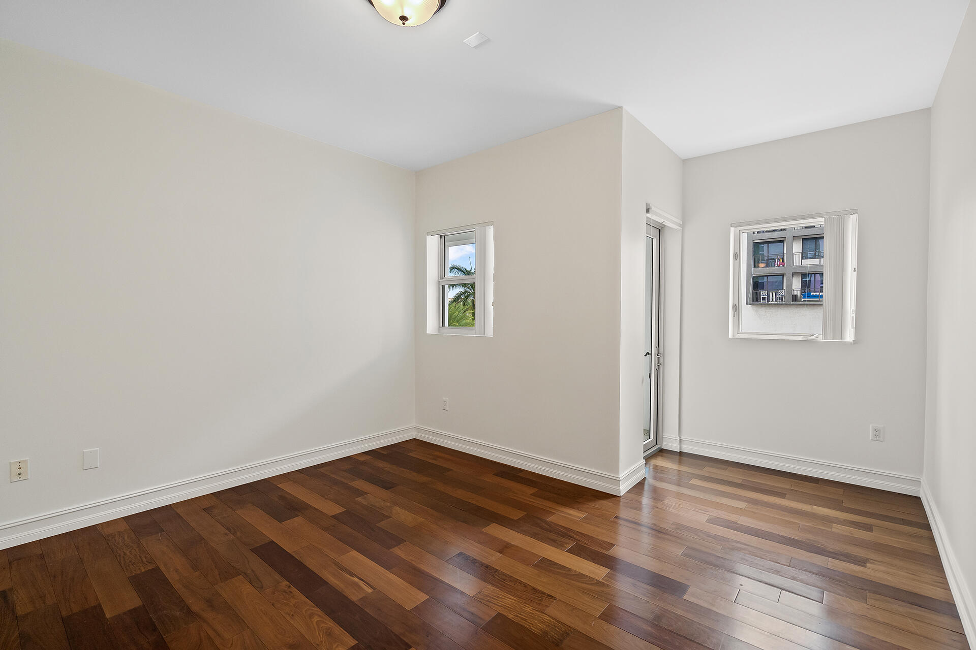 455 East Palmetto Park Road, Unit 3W Boca Raton, FL 33432 - Photo 12 of 40 an empty room with wooden floor and windows