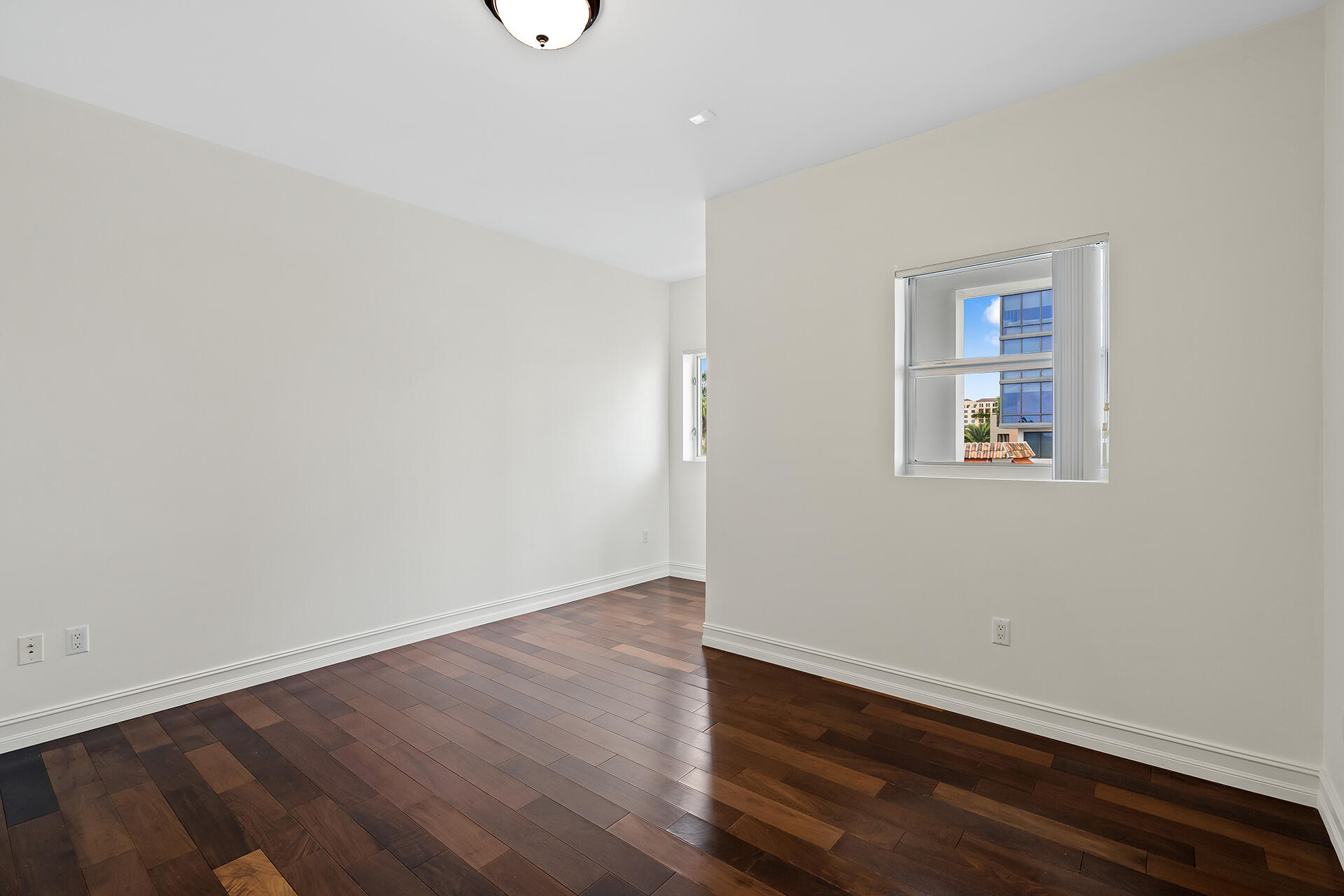 455 East Palmetto Park Road, Unit 3W Boca Raton, FL 33432 - Photo 17 of 40 an empty room with wooden floor and windows