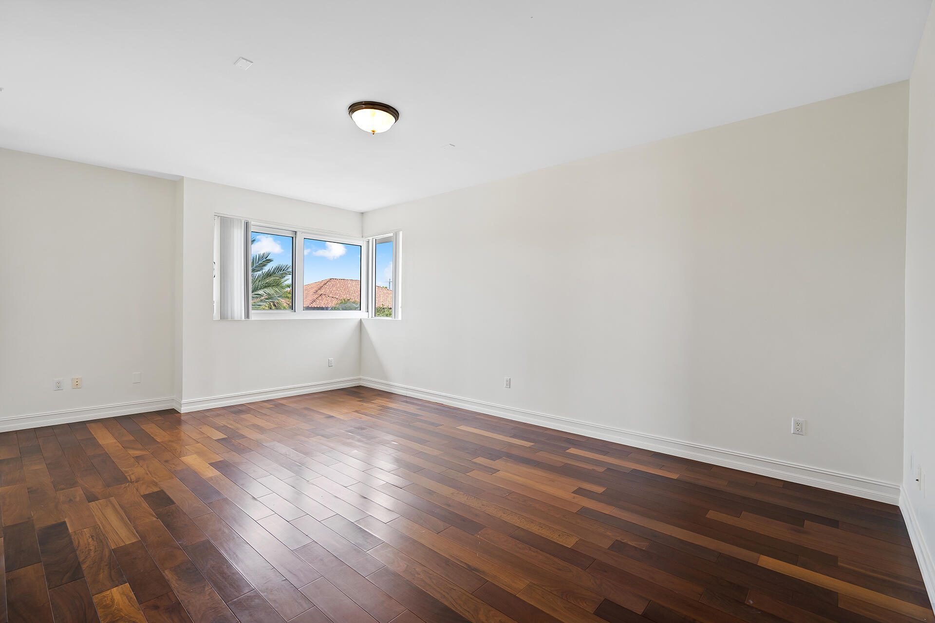 455 East Palmetto Park Road, Unit 3W Boca Raton, FL 33432 - Photo 23 of 40 an empty room with wooden floor and windows
