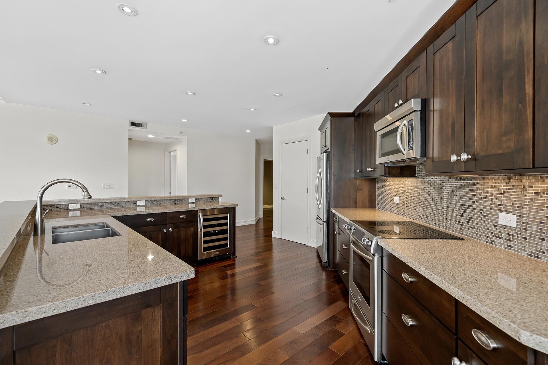 455 East Palmetto Park Road, Unit 3W Boca Raton, FL 33432 - Photo 5 of 40 a kitchen with a stove a sink and a refrigerator