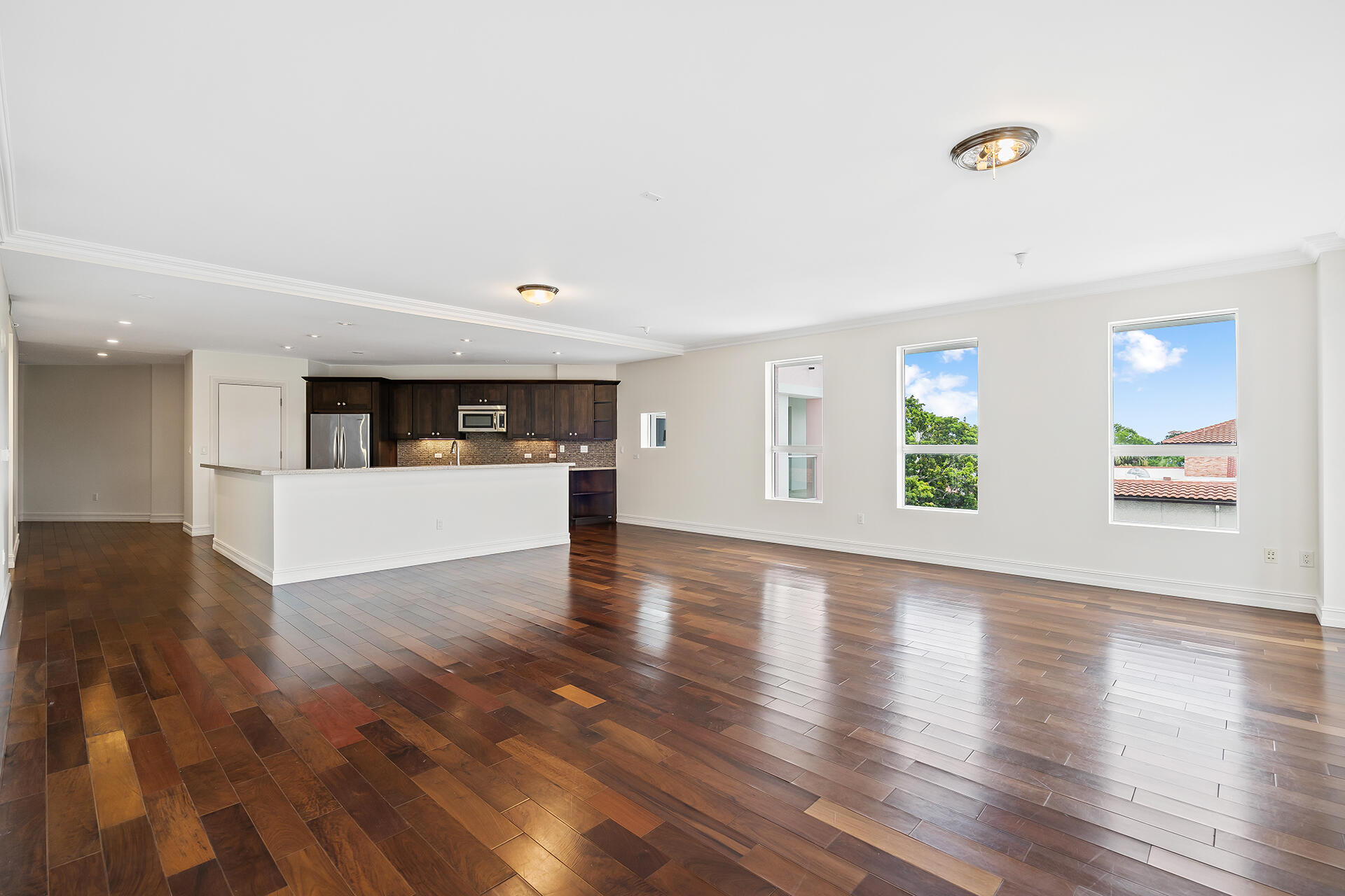 455 East Palmetto Park Road, Unit 3W Boca Raton, FL 33432 - Photo 8 of 40 a view of an empty room with wooden floor and windows
