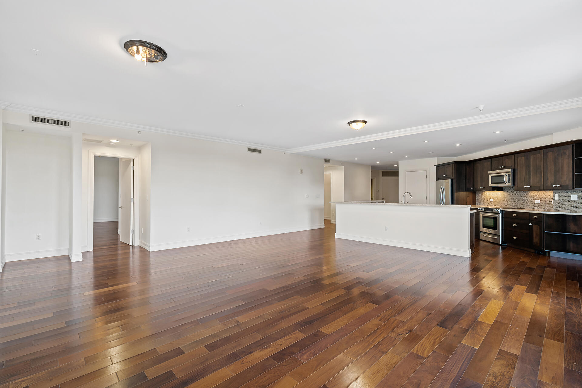 455 East Palmetto Park Road, Unit 3W Boca Raton, FL 33432 - Photo 9 of 40 a view of empty room with wooden floor and windows