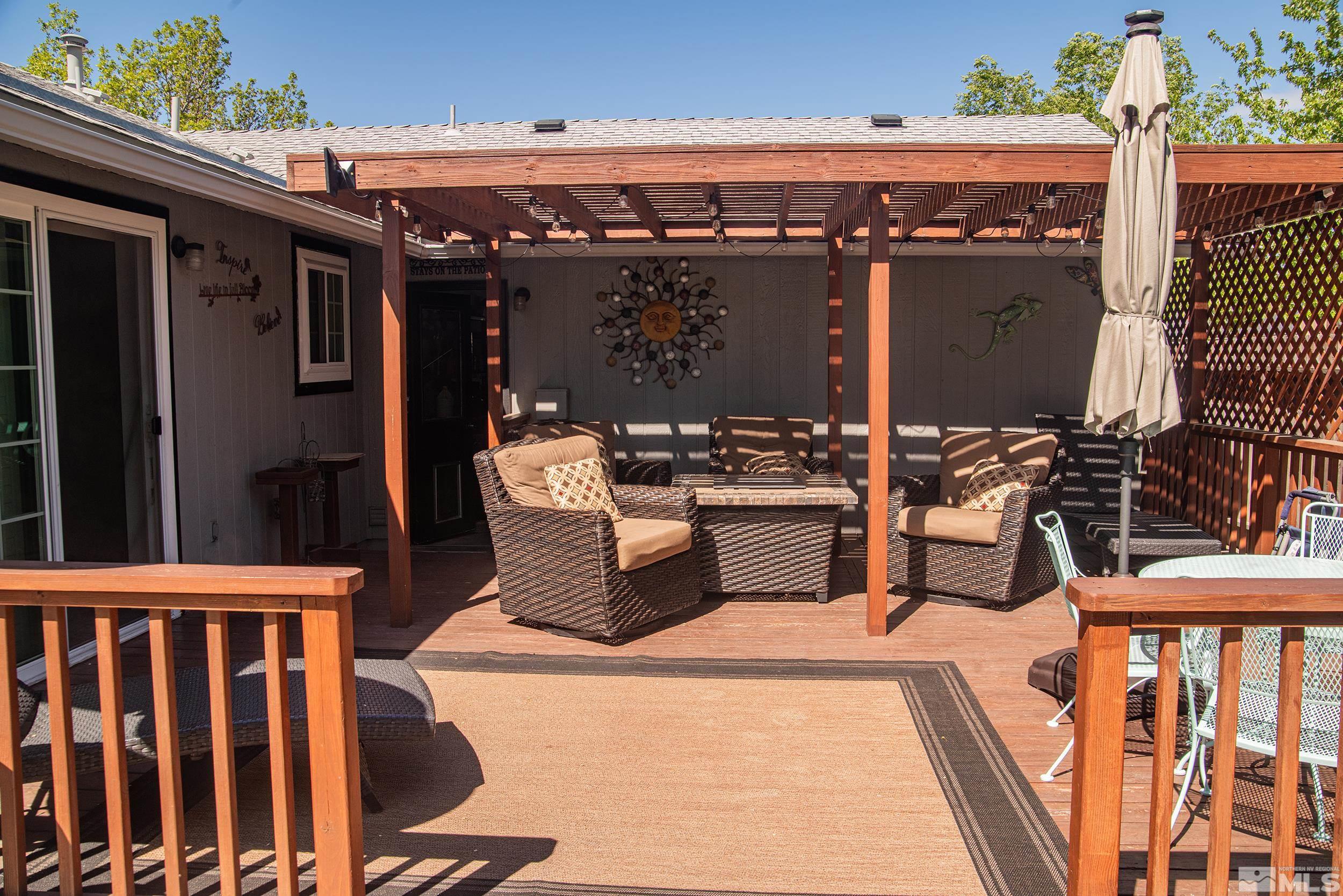 2525 Ridgecrest Drive Carson City, NV 89706 - Photo 14 of 21 a view of a patio with table and chairs