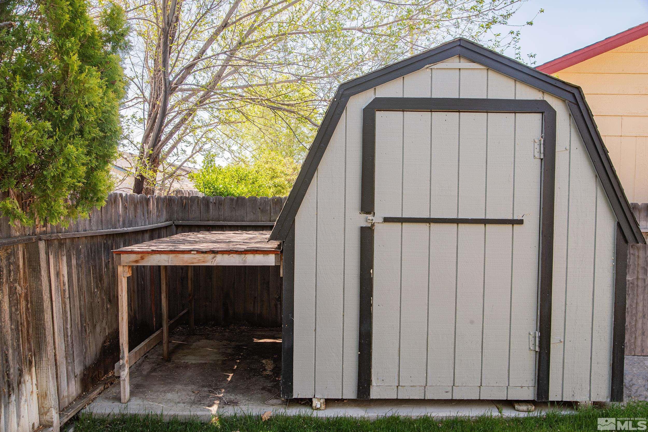 2525 Ridgecrest Drive Carson City, NV 89706 - Photo 18 of 21 a view of wooden house with a small yard and wooden fence