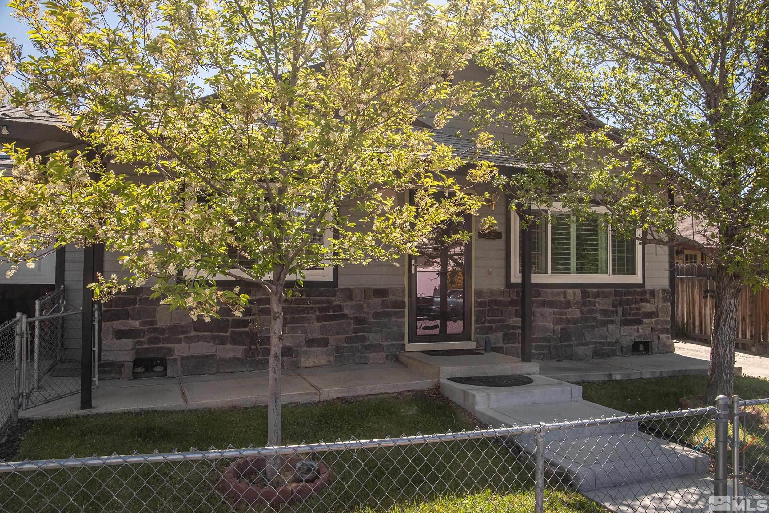 2525 Ridgecrest Drive Carson City, NV 89706 - Photo 2 of 21 a front view of a house with a garden