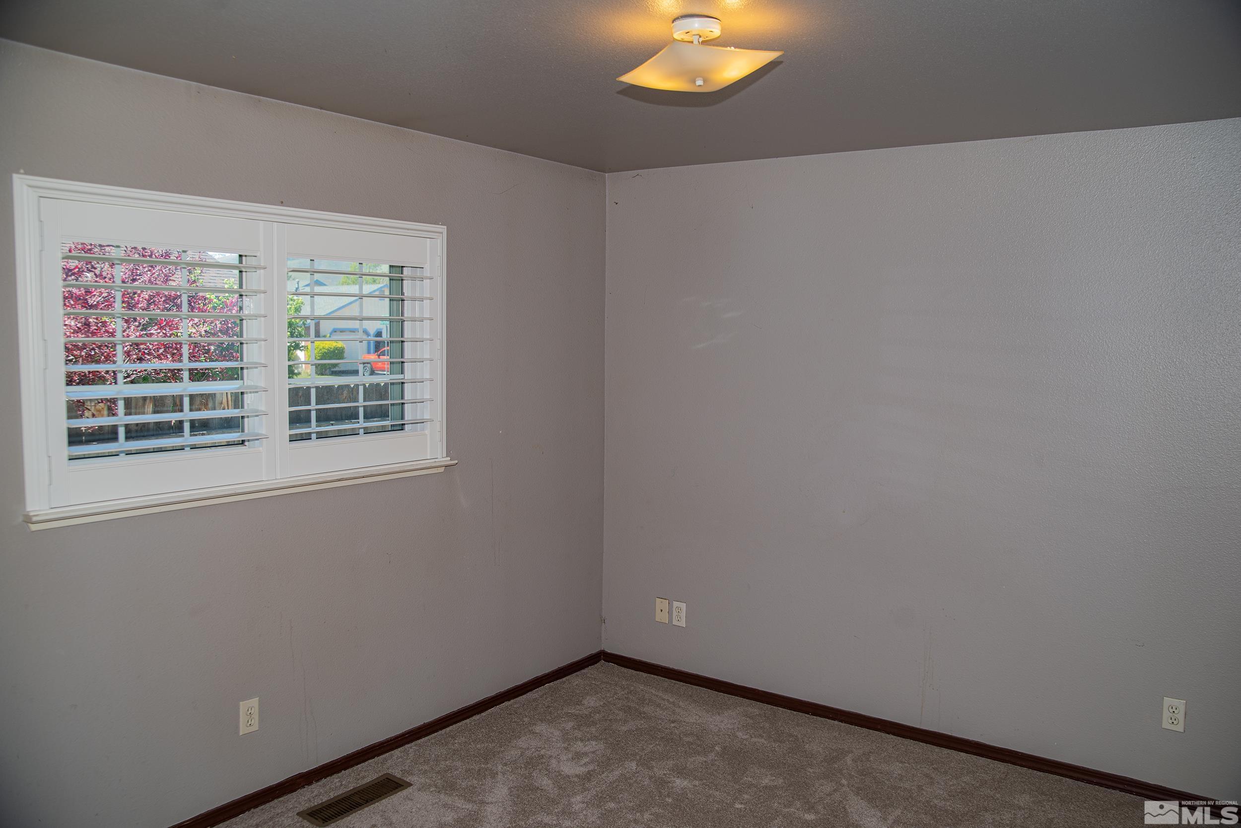 2525 Ridgecrest Drive Carson City, NV 89706 - Photo 21 of 21 an empty room with a window