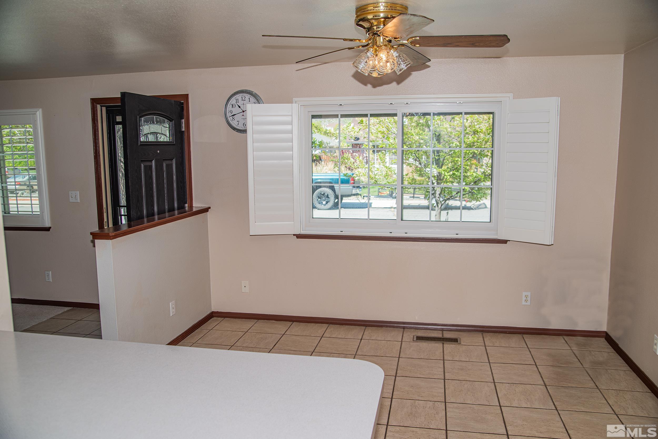 2525 Ridgecrest Drive Carson City, NV 89706 - Photo 8 of 21 a view of a livingroom with a window and a ceiling fan