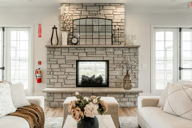a living room with furniture kitchen view and a chandelier