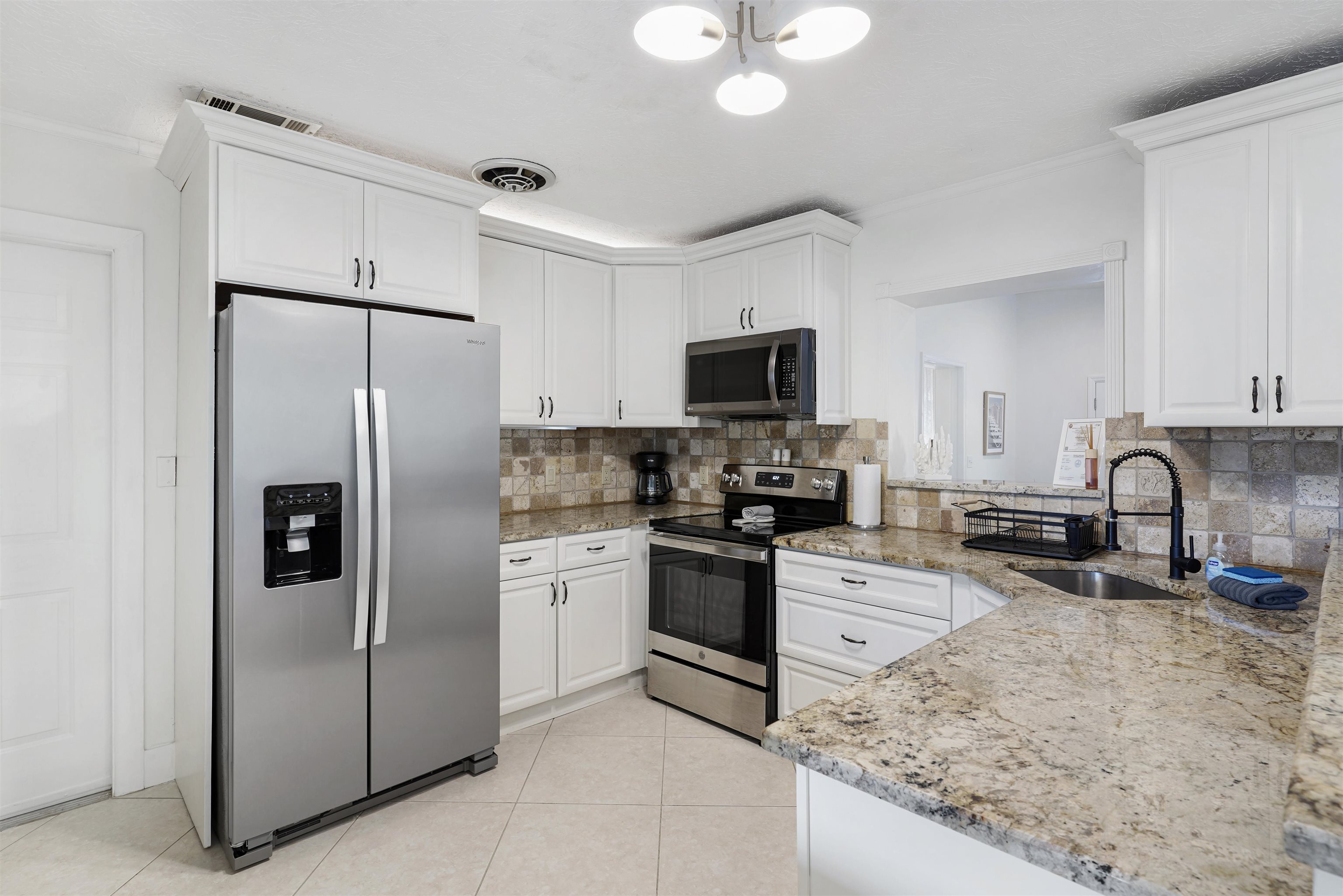 5436 4th Street St. Augustine, FL 32080 - Photo 13 of 45 a kitchen with stainless steel appliances granite countertop a refrigerator a stove top oven a sink and dishwasher