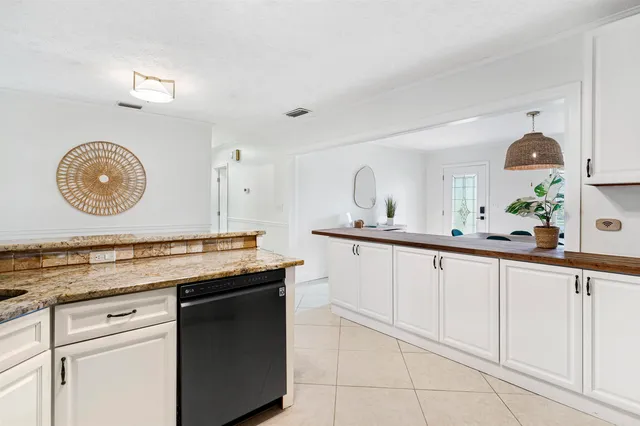 a spacious bathroom with a granite countertop sink and a mirror