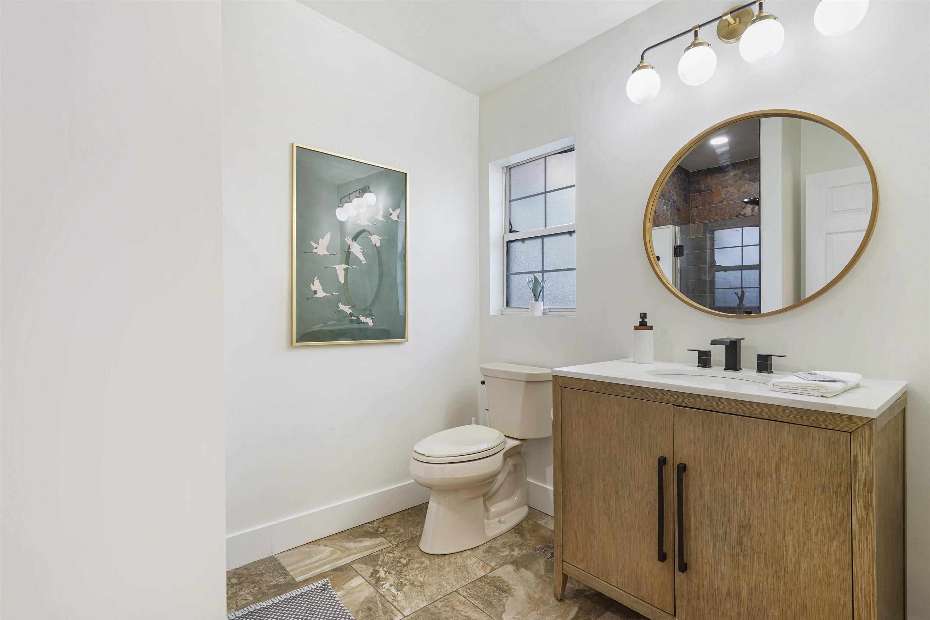5436 4th Street St. Augustine, FL 32080 - Photo 21 of 45 a bathroom with a toilet a sink and a mirror