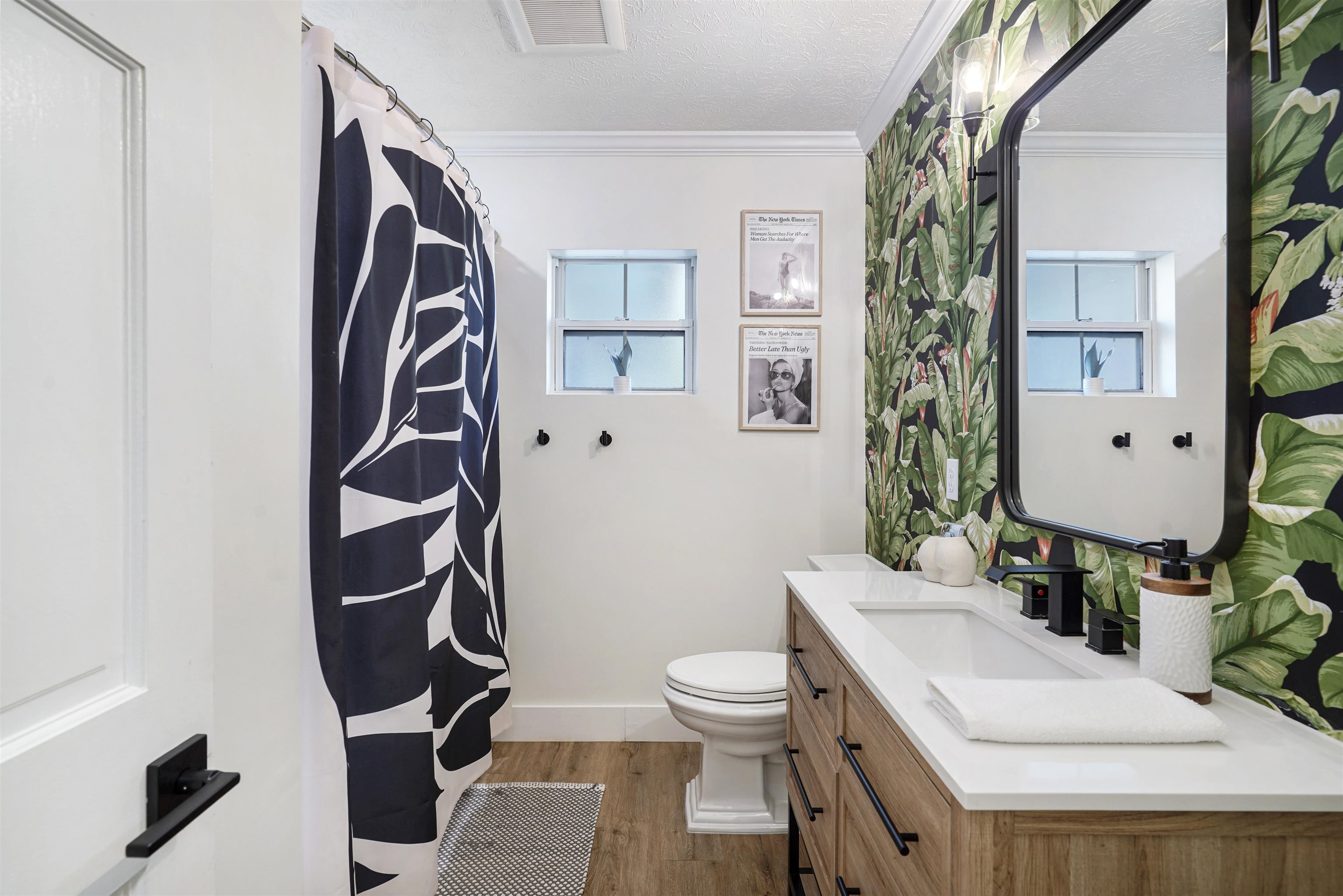 5436 4th Street St. Augustine, FL 32080 - Photo 25 of 45 a white toilet sitting next to a bathroom sink and a mirror