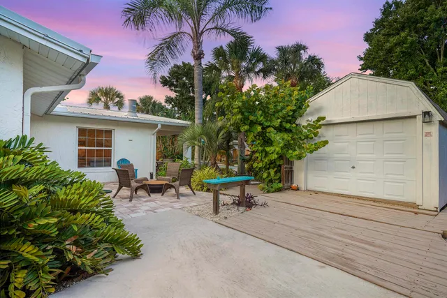 a view of a chair and table in the backyard