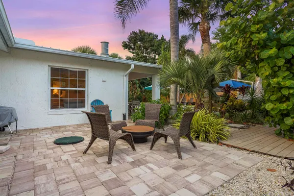 a backyard of a house with table and chairs