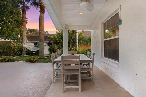 a view of a patio with a table and chairs