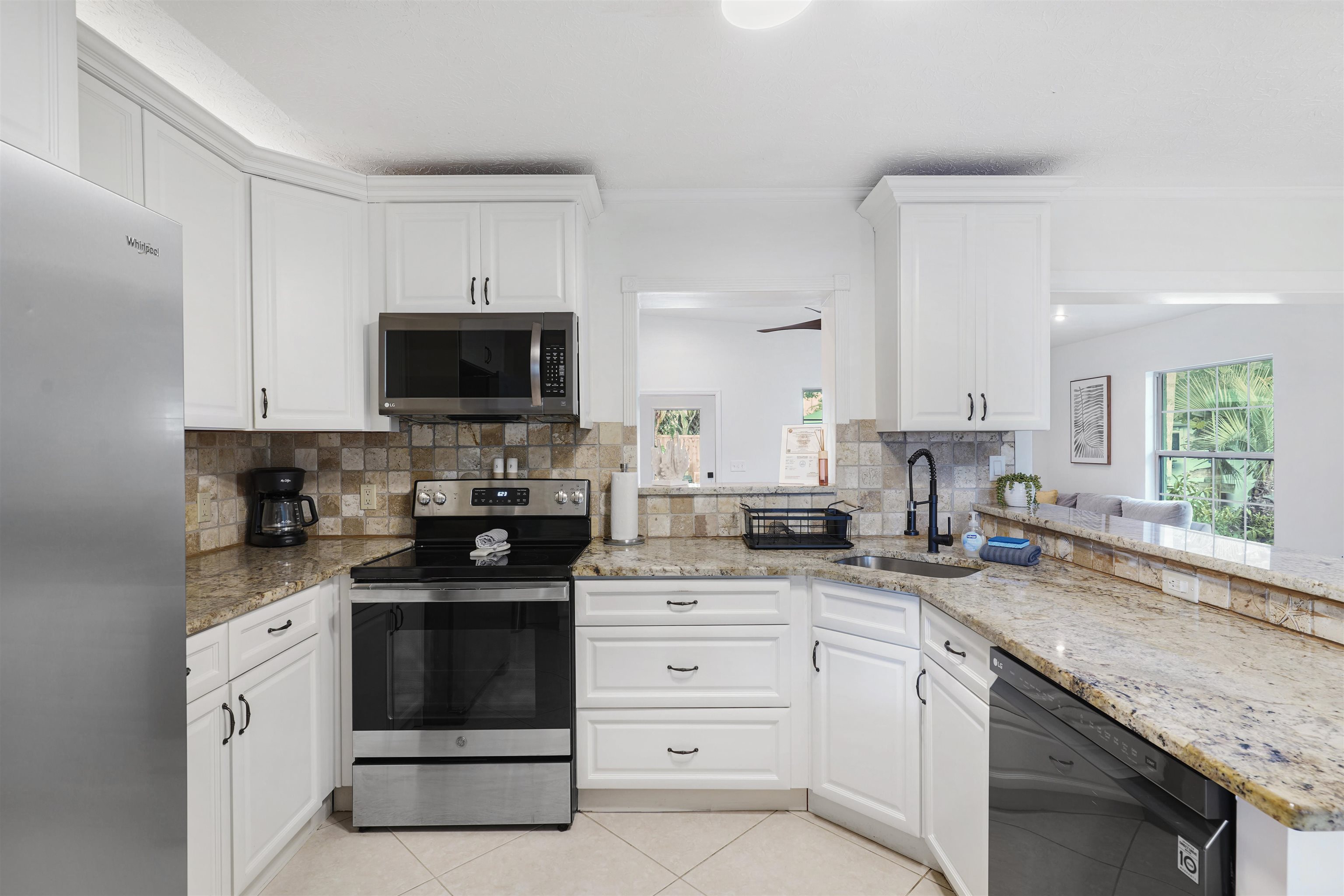 5436 4th Street St. Augustine, FL 32080 - Photo 5 of 45 a kitchen with white cabinets appliances a sink and a window