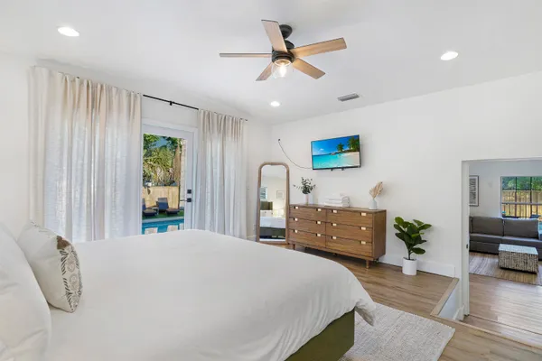 a bedroom with a bed dresser and a window