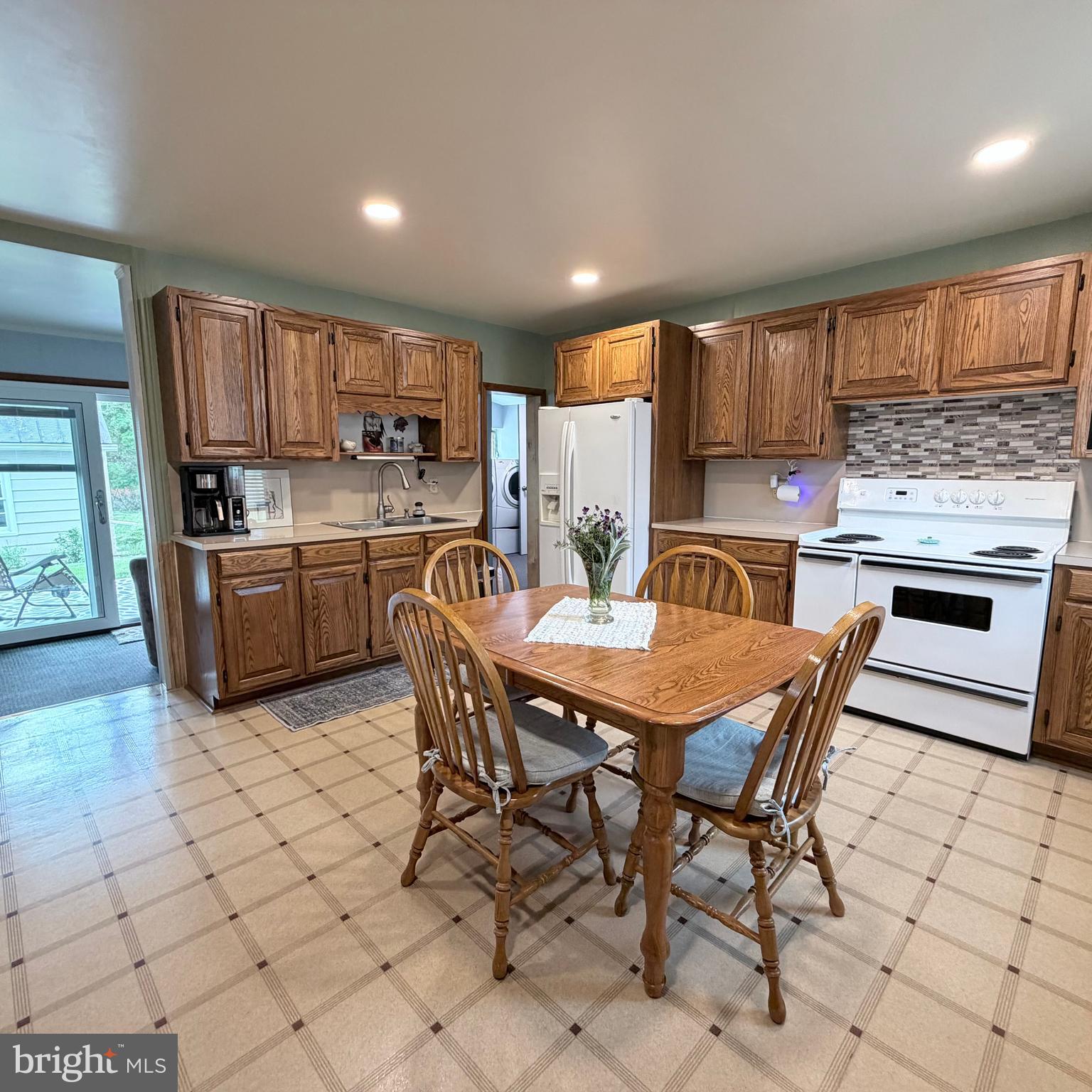 12997 Main Street Fort Loudon, PA 17224 - Photo 14 of 48 a kitchen with a table chairs a sink dishwasher and cabinets
