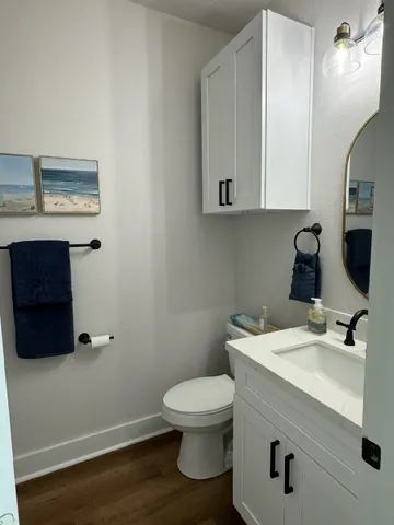 a bathroom with a sink a toilet and mirror