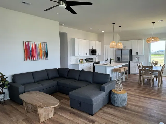 a living room with furniture and kitchen view