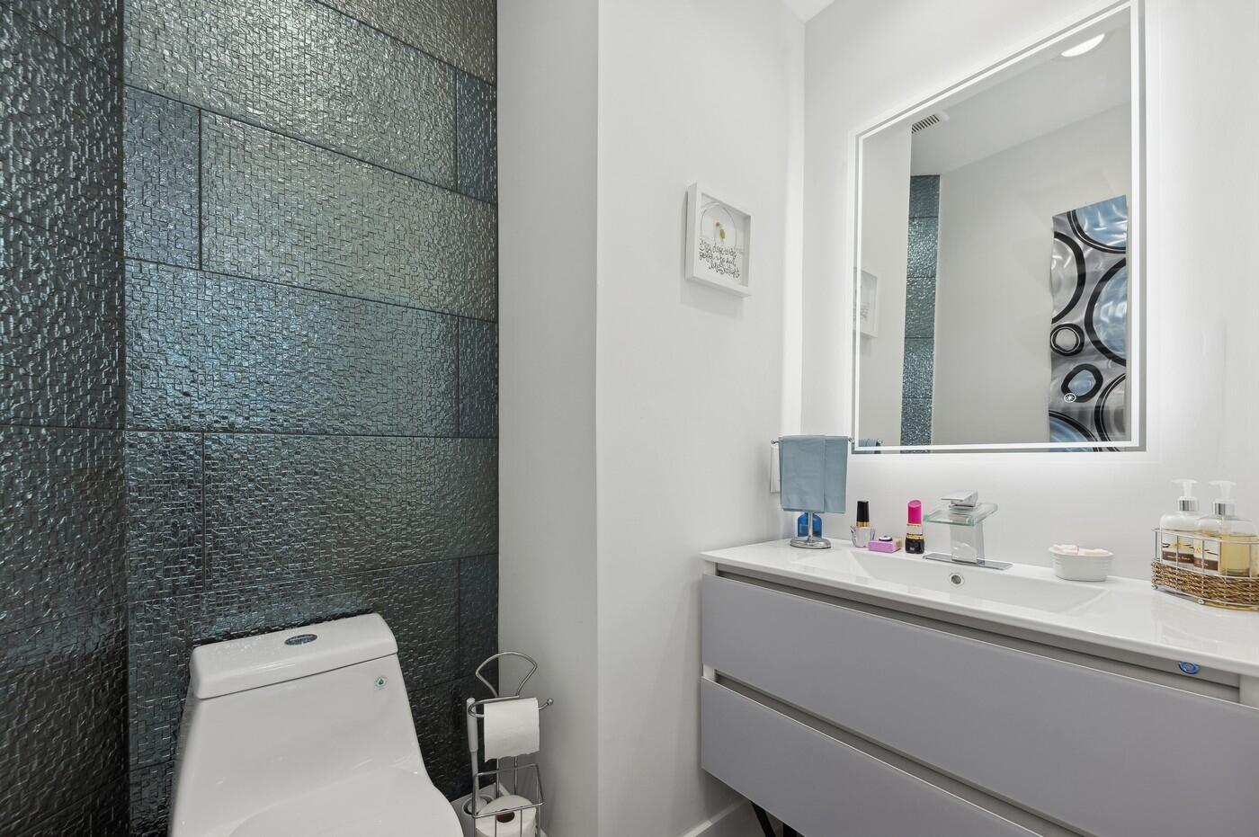 2558 Northwest 52nd Street Boca Raton, FL 33496 - Photo 14 of 27 a bathroom with a sink toilet and mirror