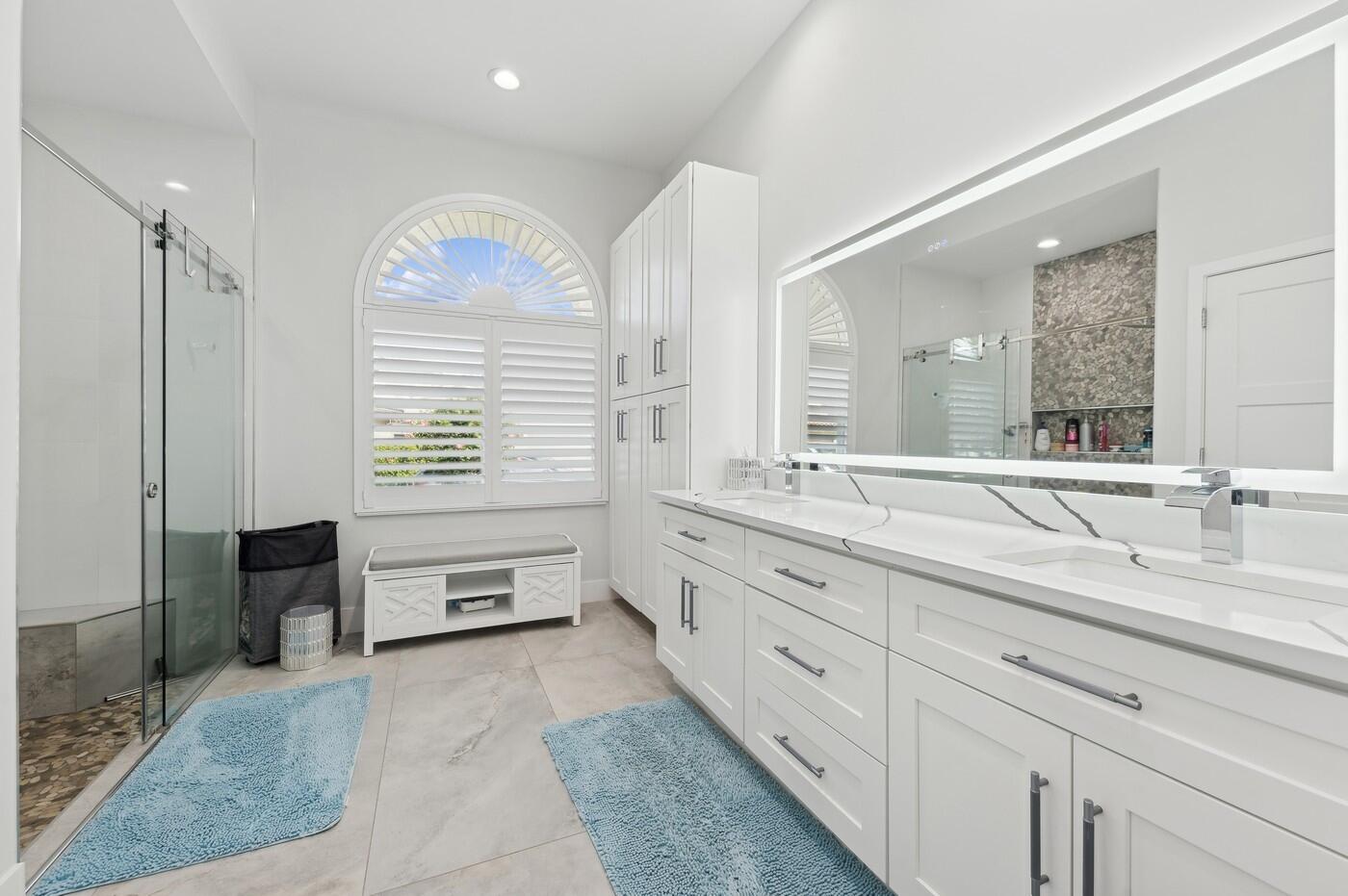 2558 Northwest 52nd Street Boca Raton, FL 33496 - Photo 17 of 27 a spacious en suite bathroom with double sink and a large mirror