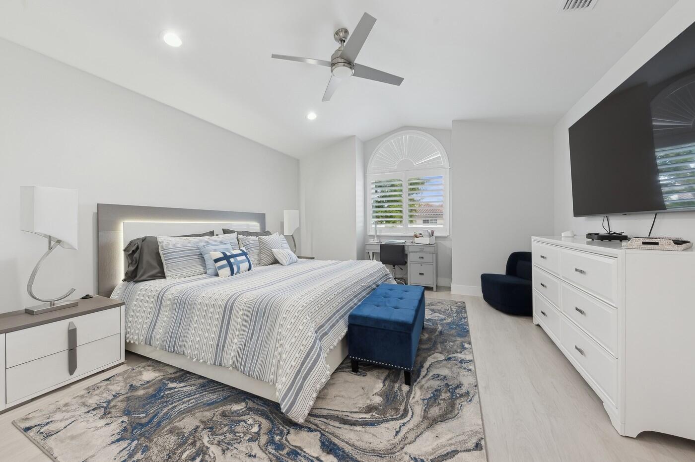 2558 Northwest 52nd Street Boca Raton, FL 33496 - Photo 19 of 27 a bedroom with a bed a window and a chandelier