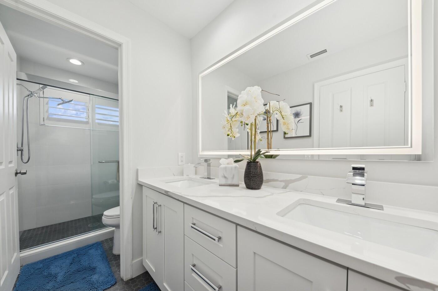 2558 Northwest 52nd Street Boca Raton, FL 33496 - Photo 21 of 27 a bathroom with a sink a toilet and shower