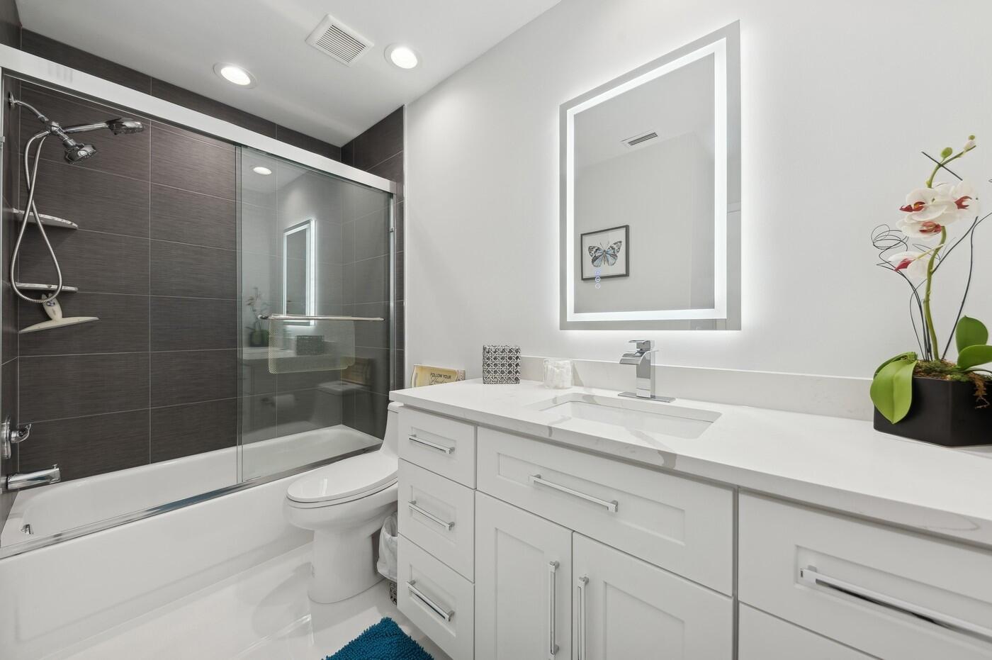 2558 Northwest 52nd Street Boca Raton, FL 33496 - Photo 22 of 27 a bathroom with a sink a toilet and shower