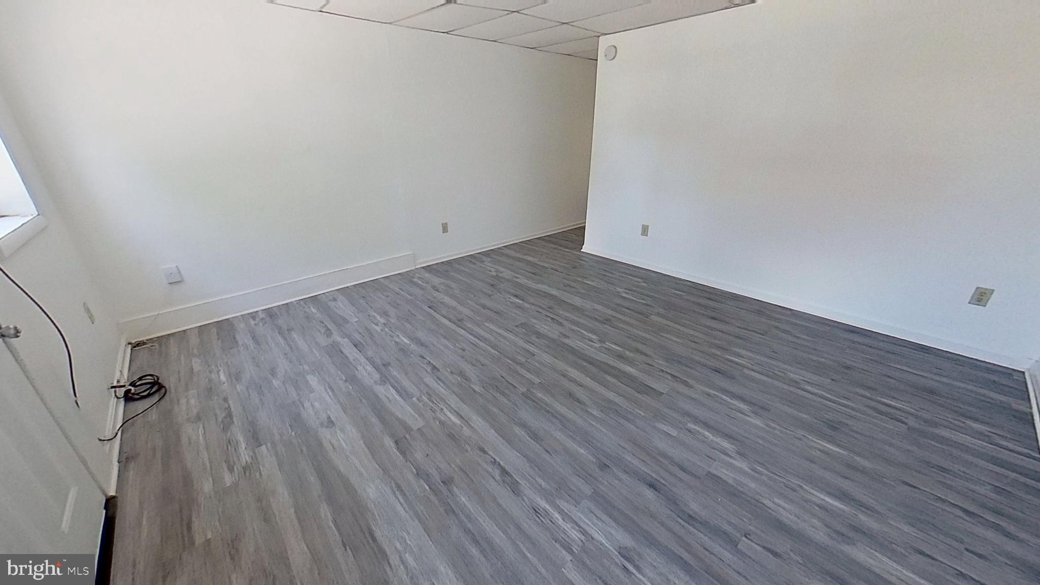 648 Broadway, Unit A Hanover, PA 17331 - Photo 3 of 10 an empty room with wooden floor
