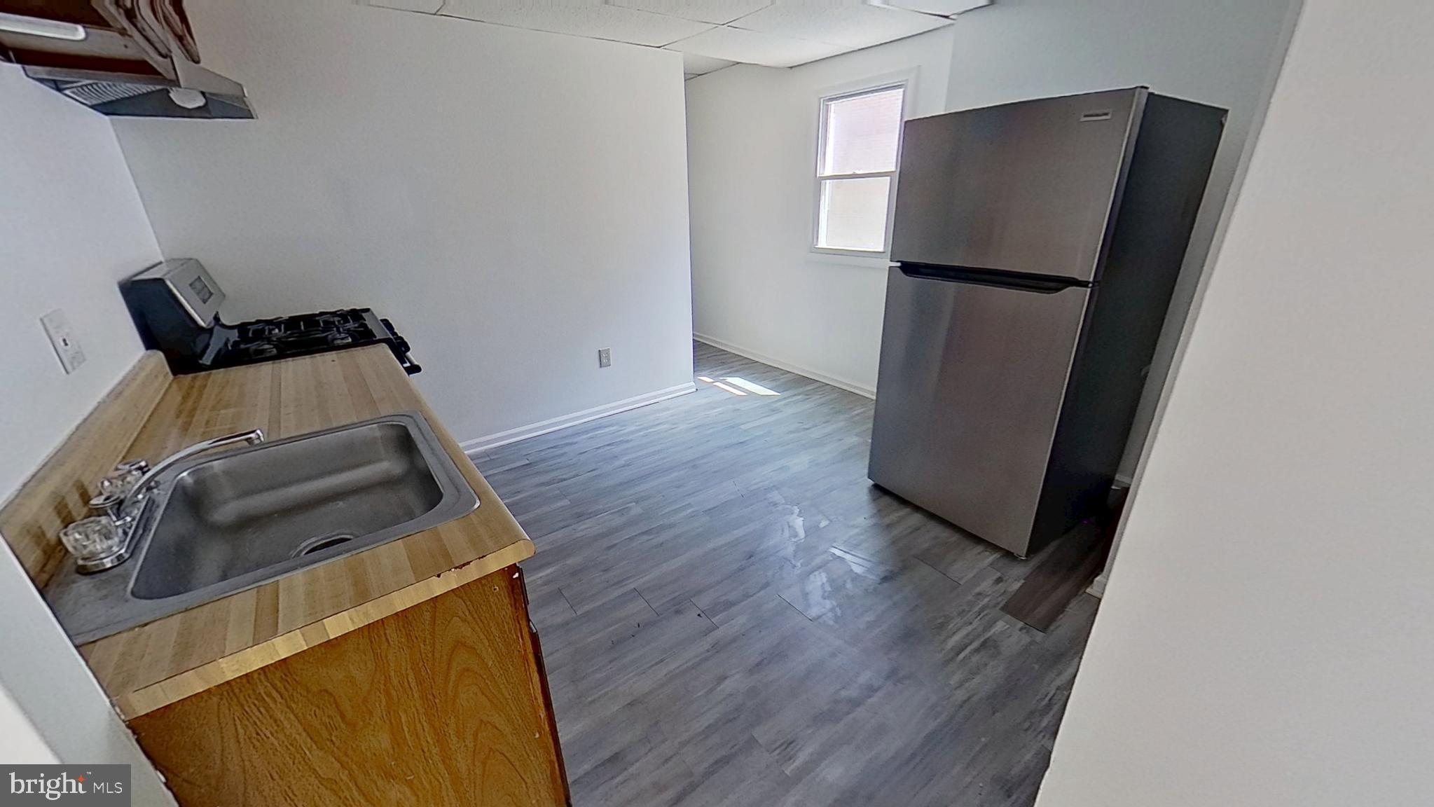 648 Broadway, Unit A Hanover, PA 17331 - Photo 4 of 10 a utility room with wooden floor washer and dryer