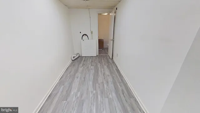 a view of a room with wooden floor