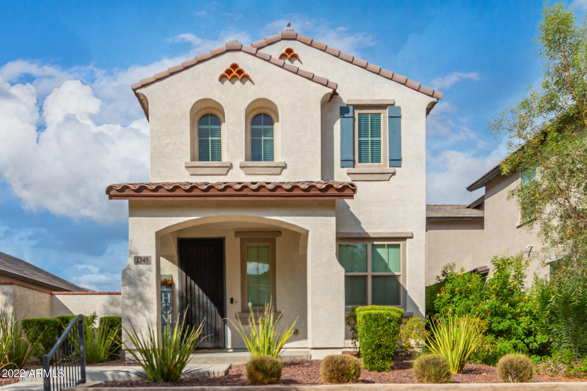 2345 North Alsap Road Buckeye, AZ 85396 - Photo 1 of 50 a view of a white house with large windows and a small yard