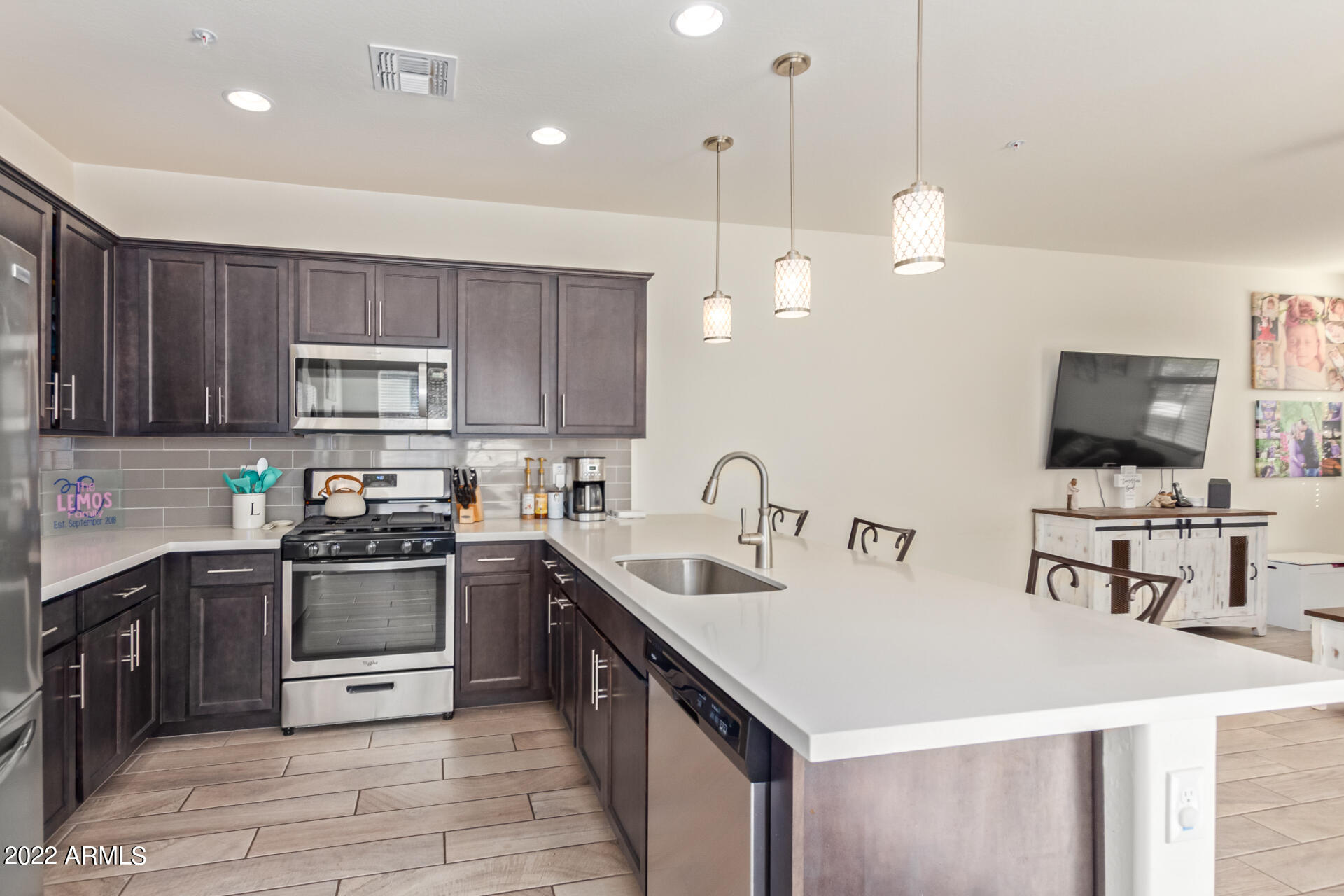 2345 North Alsap Road Buckeye, AZ 85396 - Photo 14 of 50 a kitchen with a sink a stove and chairs