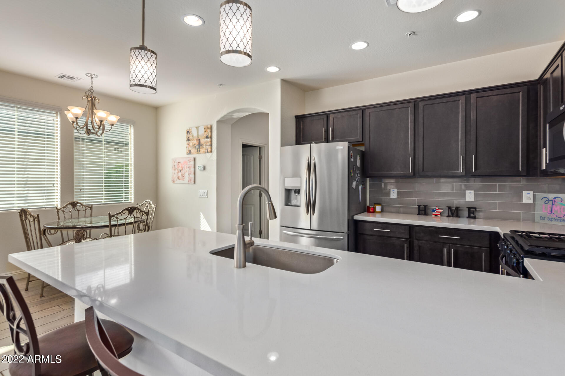 2345 North Alsap Road Buckeye, AZ 85396 - Photo 16 of 50 a kitchen with refrigerator a sink and cabinets