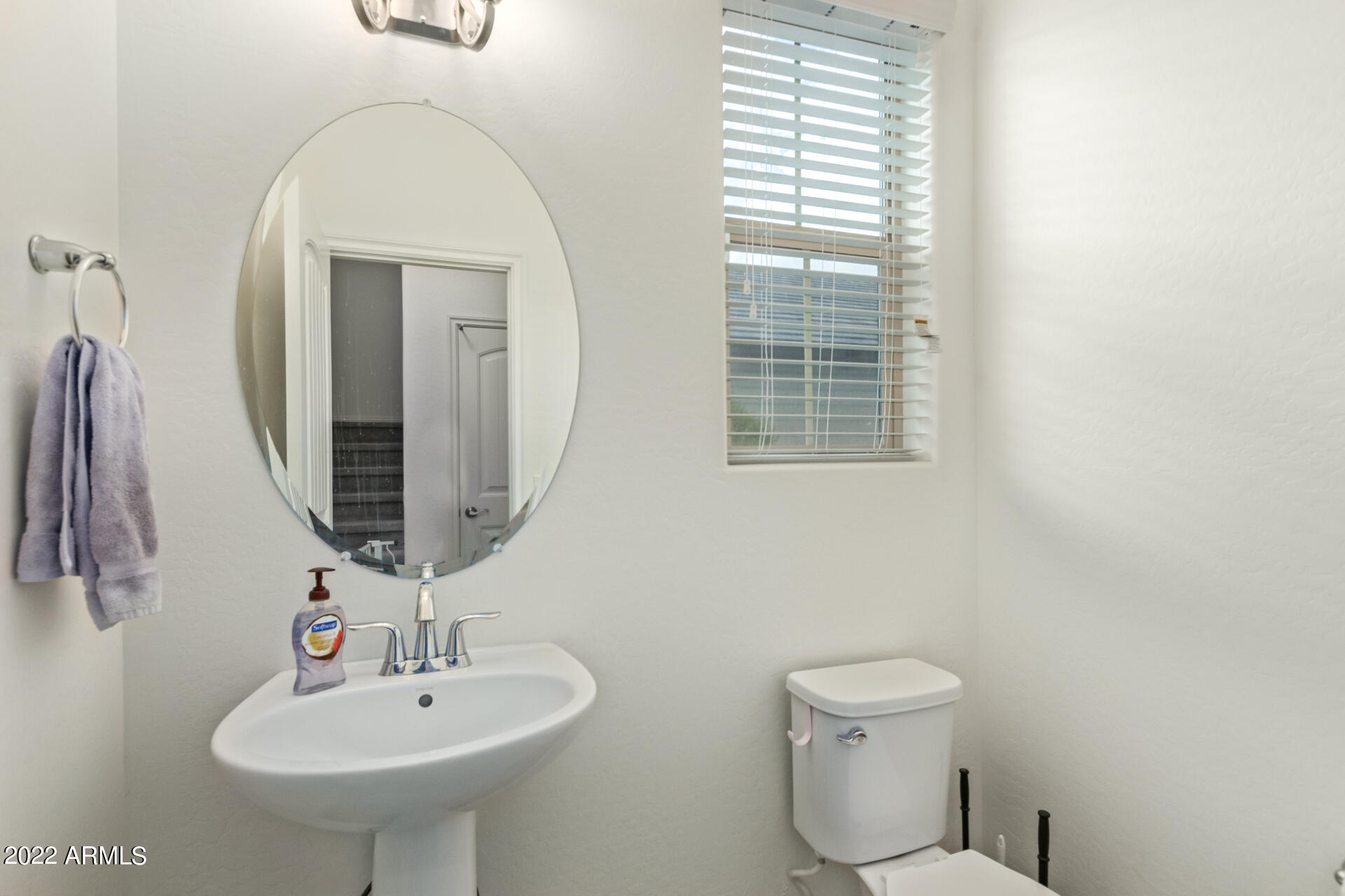 2345 North Alsap Road Buckeye, AZ 85396 - Photo 17 of 50 a bathroom with a toilet sink and mirror