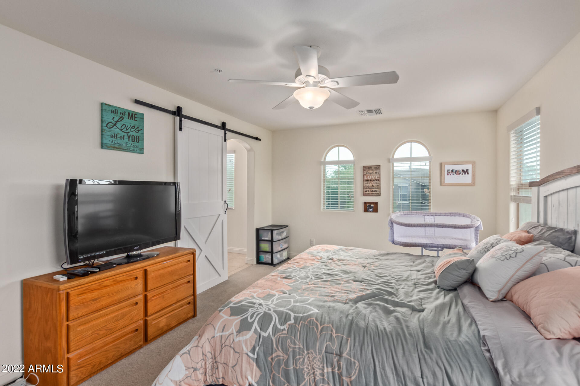 2345 North Alsap Road Buckeye, AZ 85396 - Photo 19 of 50 a bedroom with a bed and a flat screen tv on dresser