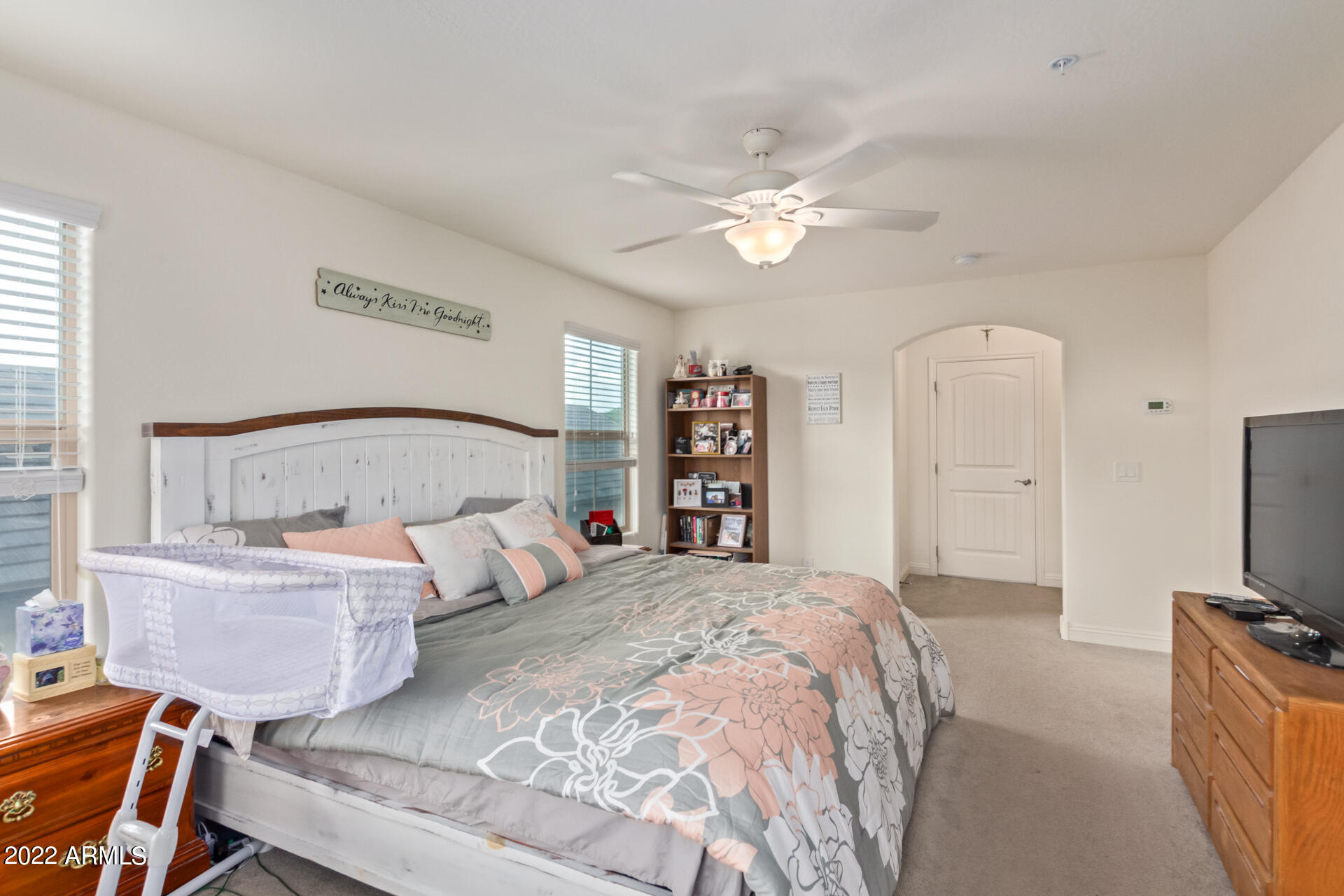 2345 North Alsap Road Buckeye, AZ 85396 - Photo 20 of 50 a bedroom with a large bed and a flat tv screen on a dresser