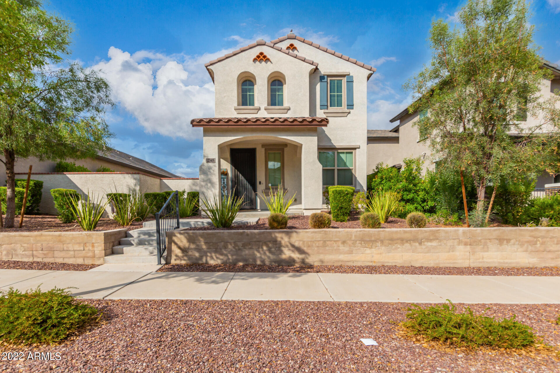 2345 North Alsap Road Buckeye, AZ 85396 - Photo 2 of 50 a view of white house with a small yard and large tree