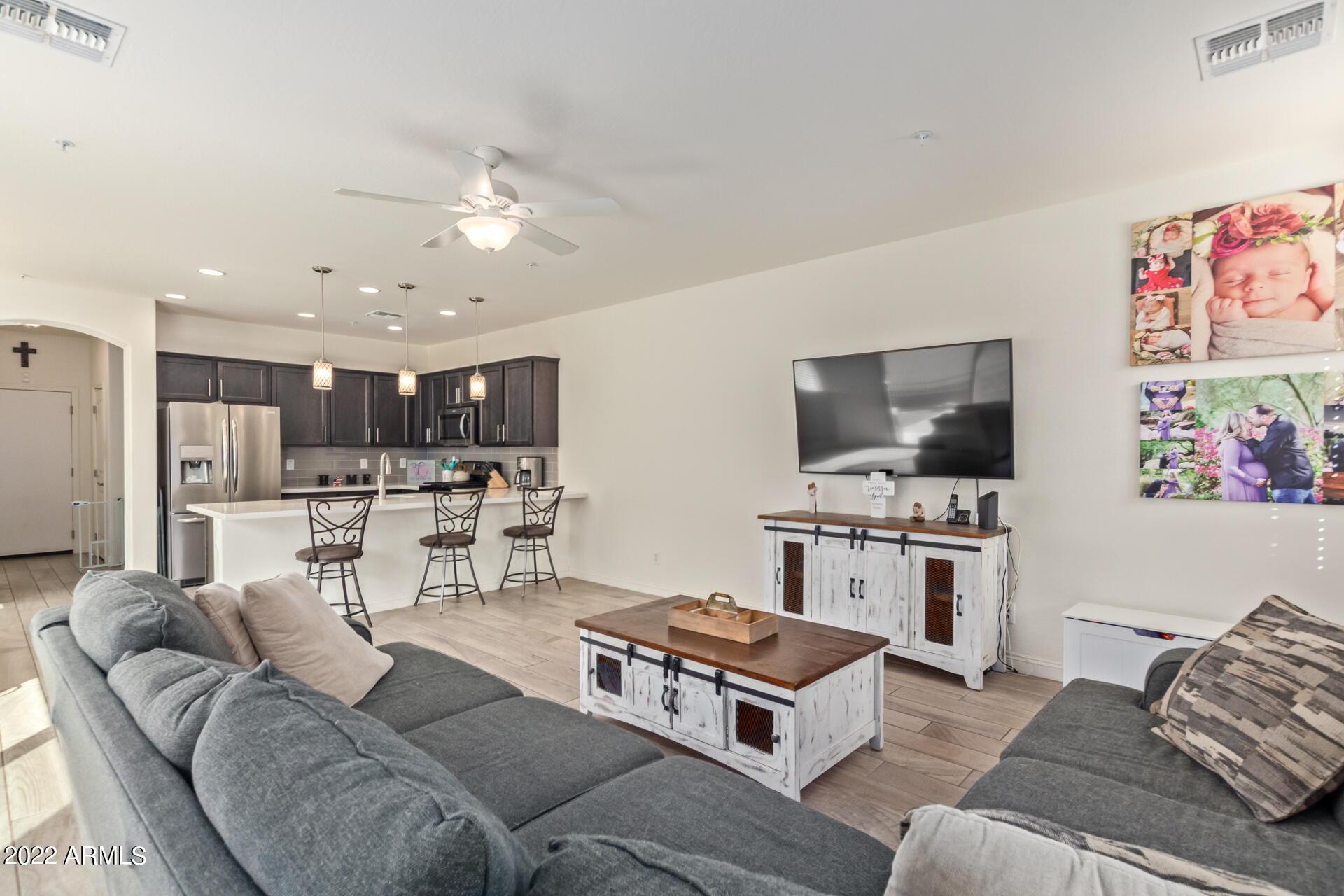 2345 North Alsap Road Buckeye, AZ 85396 - Photo 9 of 50 a living room with furniture kitchen view and a flat screen tv
