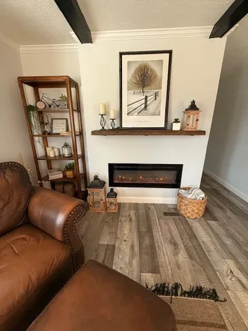 a living room with furniture and a painting