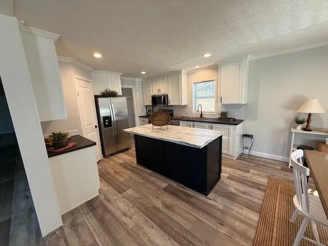 a kitchen with a sink stove and refrigerator