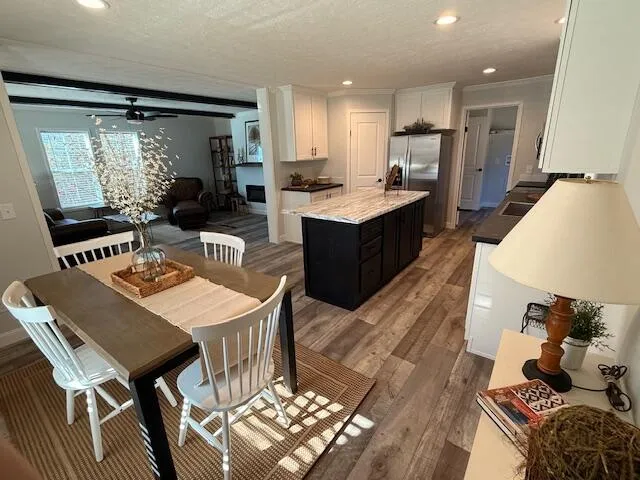 a large kitchen with a table and chairs