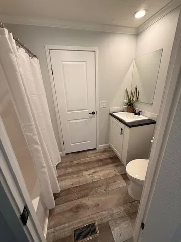 a bathroom with a sink a toilet and a mirror
