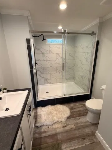 a bathroom with a glass shower door
