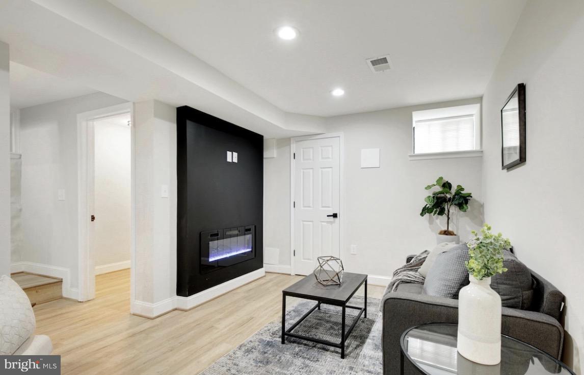 5300 Maple Avenue Baltimore, MD 21215 - Photo 9 of 13 Modern basement retreat with cozy vibes.