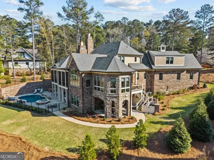 an aerial view of a house with a swimming pool