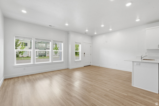 1173 West 1870 South Logan, UT 84321 - Photo 3 of 33 Open-concept living space with light wood-finish flooring, white walls, and recessed lighting